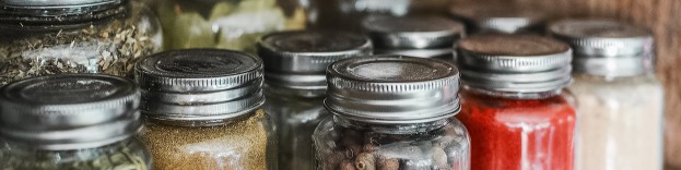 An image of multiple mason jars that are being used to decorate a traditional kitchen.