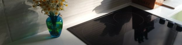 An image of a black hob embedded in the worktop