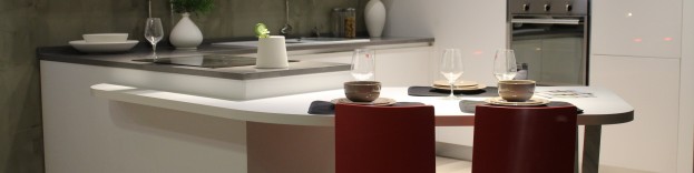 An image of a modern kitchen with a white curved cupboard design.