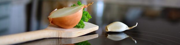 An image of a ceramic hob with food on the top.